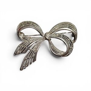 Vintage Kenney Jay Lane gold-tone brooch with clear rhinestones.